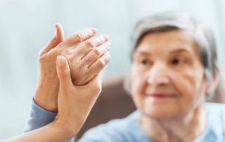 Seniors hand being held